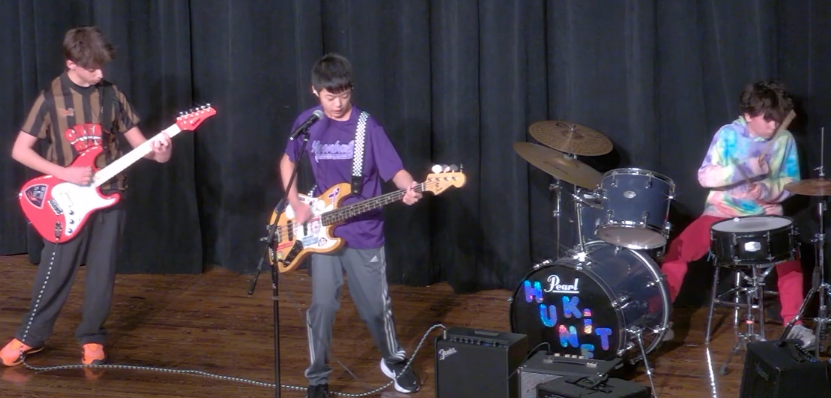 Winners Oliver Foster-Wu, Thomas Wares and Matthew Moon perform at this year's DFMS Talent Show.